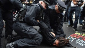 Protester being held down by police at G8 protest
