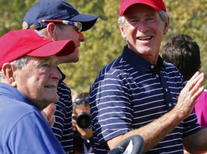 Former U.S. president W. Bush talks to U.S. vice captain Verplank next to former president H.W. Bush during the afternoon four-ball round at the 39th Ryder Cup golf matches at the Medinah Country Club