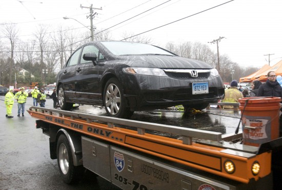 Car driven by Connecticut school shooter Lanza is towed from Sandy Hook Elementary School in Newtown,