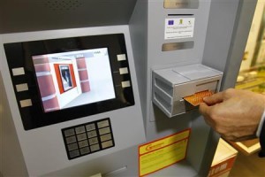 MB Telecom president and co-inventor of "Secure Revolving System-SRS" Tudor shows protection system on a prototype ATM in Bucharest